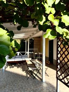 a patio with two chairs and a table and a table at Camere con piscina Tenuta BRICCHETTO in Castagneto Po
