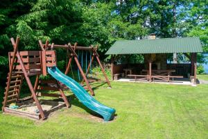 a playground with a slide and a gazebo at Agroturystyka Nad Hańcza in Błaskowizna