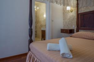 a bedroom with a bed with towels on it at Valletta Suite Drew in Valletta