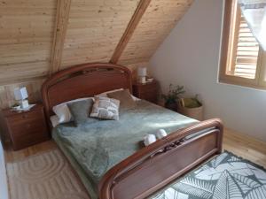 a bedroom with a large bed in a room at Kuća za odmor Urša in Brod na Kupi