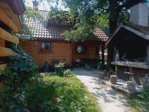 an outside view of a house with a patio at Kuća za odmor Urša in Brod na Kupi