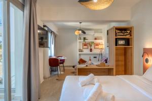 a bedroom with a bed and a desk and a room at Soluna Forte Sea Living Suites in Palaiokastro +88 photos