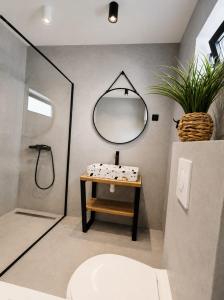 a bathroom with a sink and a mirror at Apartment Luka in Tučepi +4 photos
