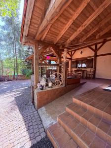 an outdoor pavilion with a wooden roof and stairs at House of Aurora in Šwidnik