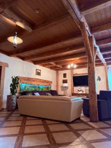 a large living room with a large couch in a room at House of Aurora in Šwidnik