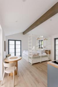 a white room with a table and two bunk beds at Villa Eva in Ajdovščina