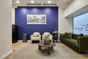 a living room with a couch and two chairs at Mantra Adelaide Central in Adelaide