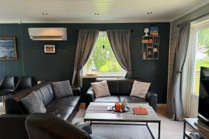 a living room with a couch and a table at Panorama Valley Lofoten in Bøstad