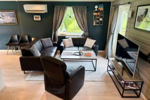 a living room with a couch and a table at Panorama Valley Lofoten in Bøstad