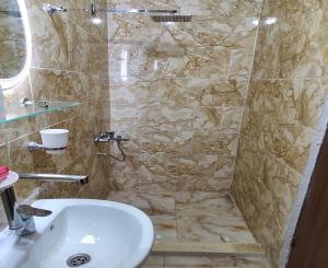 a bathroom with a sink and a shower at Sunset Mirage House in Giza +79 photos