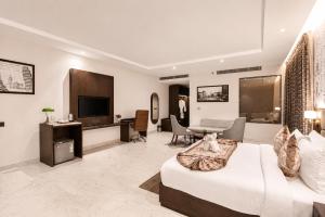 a bedroom with a bed and a living room at Lotus Vista Hotel in Alwar