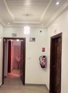 a hallway with a bathroom with a sink and a door at Hotel Résidence Awa Plazza 2 in Dakar +16 photos