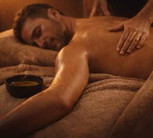 a man sleeping in a bed with a bowl at Abaca Colors in Saint-Martin-de-Seignanx