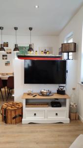a large television on a white entertainment center in a living room at Ferienhaus Happytime in Binz