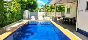 a swimming pool in the backyard of a house at Pranburi Private Pool Villa Baan Prae by Baan Chaylay in Pran Buri