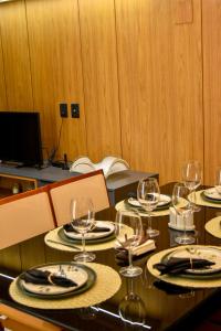 a table with wine glasses and plates on it at Sossego na serra vista para vale e lazer completo in Bananeiras +76 photos