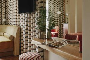 a living room with a table and a couch at Locke am Platz Zurich in Zurich