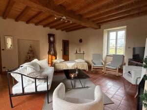 a living room with a bed and a table and chairs at Le Château de Leugny in Oiron