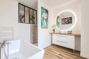 a bathroom with a sink and a mirror at La Maison Opaline in Reims +54 photos
