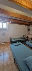 a room with two beds and a fan in it at Appartement plein centre-ville in Lodève