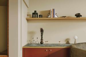 a kitchen with a counter with scissors and a shelf at Locke am Platz Zurich in Zurich +12 photos