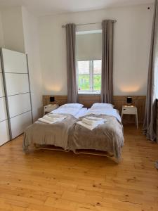 a bedroom with a large bed and a window at Skelby Præstegård lej 1 in Gedser