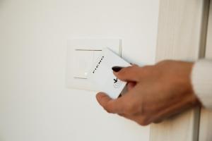 a hand holding a light switch with the word turn on at Ca' Foega rooms in Chioggia