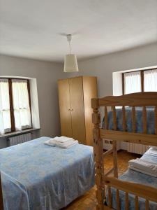 a bedroom with a bed and a bunk bed at Albergo Nonaj in Monticello d'Alba
