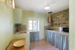 a kitchen with a sink and a counter top at Pietra Viva in Poggio +38 photos
