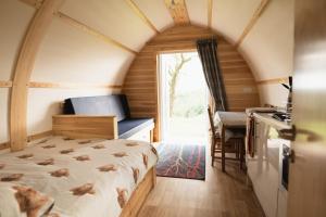 a bedroom with a bed in a tiny house at Rivendell Farm Glamping in Carmarthen