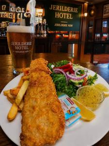 a plate of food with fish and french fries and a salad at Jerilderie Hotel - Pub, Restaurant & Accommodation in Jerilderie