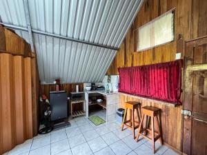 a room with a desk and a red curtain at Cabaña Escondida Rio Celeste in El pilon