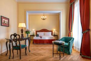 a hotel room with a bed and a table and a chair at Grand Hotel Majestic in Verbania