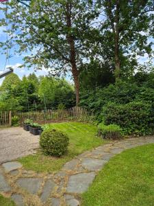 a garden with a stone path and a wooden fence at Ferienwohnung Greitemann in Eslohe