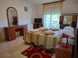 a bedroom with a large bed and a mirror at Club Onix Apartments in Neptun
