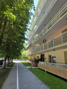 an apartment building with a walkway in front of it at Club Onix Apartments in Neptun