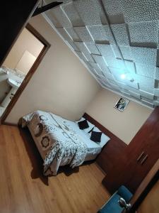 a small bedroom with a bed in a attic at Hostal el barranco in Cuenca