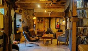 a living room with two chairs and a fireplace at Chez Walter et Camille in Saint-Cernin-de-Larche