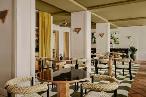 a dining room with tables and chairs in a room at Locke am Platz Zurich in Zurich
