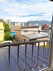 a balcony with a view of a city at Guest House Asahi in Otaru