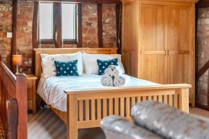a bedroom with a bed with two towels on it at Barn Conversion Sleeps 2 with Parking in Diss