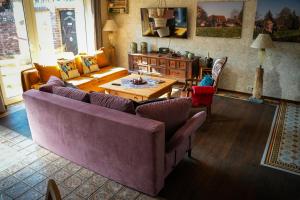a living room with a purple couch and a table at Ferienwohnung WohlFühlWohn in Vreden