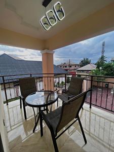a balcony with a table and chairs on a balcony at Davic-Mart Apartments Port Harcourt in Umudara