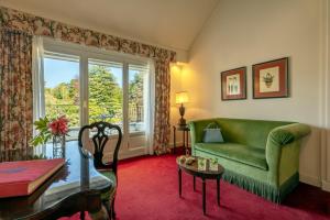 a living room with a green couch and a table at Grand Hotel Majestic in Verbania +114 photos