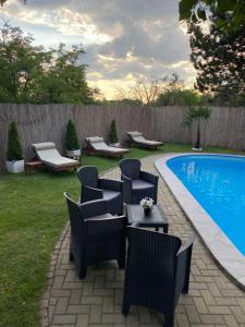 a backyard with a pool with chairs and a table next to at Pool House in Subotica +33 photos