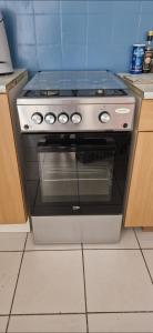 a stainless steel stove in a kitchen at Appartement plein centre-ville in Lodève