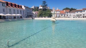 a large pool of water in the middle of a city at Casa dos Tios- Estremoz in Estremoz