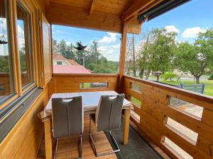 a wooden porch with a table and two chairs at Blockhaus Nikolaus in Güssing