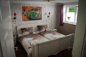 a bed in a bedroom with a painting on the wall at Ferienwohnung WohlFühlWohn in Vreden