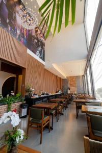 a restaurant with wooden tables and chairs in a room at AIRPORT HOTEL GRU LTDa in Guarulhos